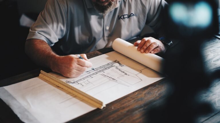 Architectural blueprints and drafting tools on a desk