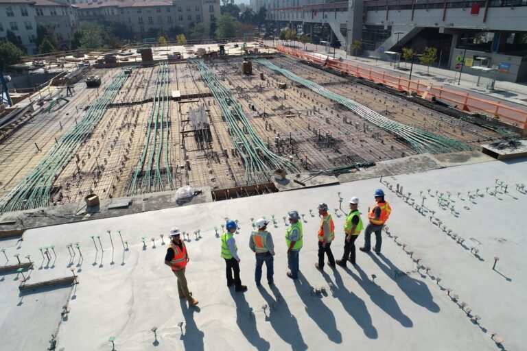 Construction workers reviewing documents on a building site